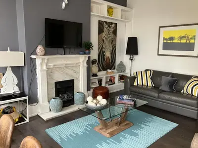 a living room with a couch and a fireplace at Apartment 28 in Ayr