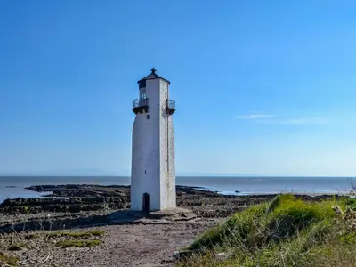 a lighthouse on the shore of the ocean at Quare Place in Mainsriddle