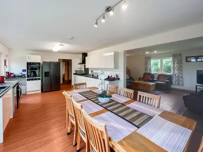 a dining room and kitchen with a table and chairs at Quare Place in Mainsriddle
