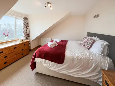 a bedroom with a bed and a sink and a window at Quare Place in Mainsriddle