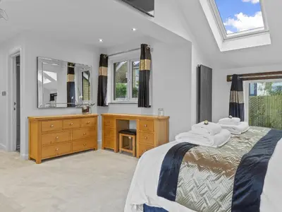 a bedroom with a bed and a sink and mirror at Finest Retreats - Willow Dene in Cockermouth
