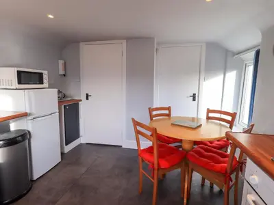a kitchen with a table and chairs and a kitchen with a refrigerator at Lakeland View Lodge in Keswick