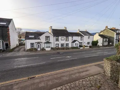 a row of white houses on the side of a street at Lakeland View Lodge in Keswick