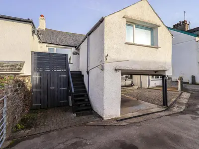 a house with a gate and a stairway to a garage at Lakeland View Lodge in Keswick