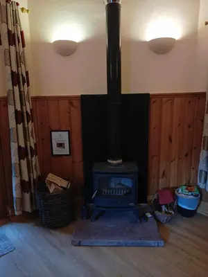 a fireplace in a room with a stove at The Dairy - Patterdale Hall in Penrith