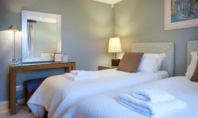a hotel room with two beds with towels on them at Blencathra in Keswick