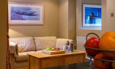 a living room with a couch and a table at Underscar - Stonethwaite in Keswick