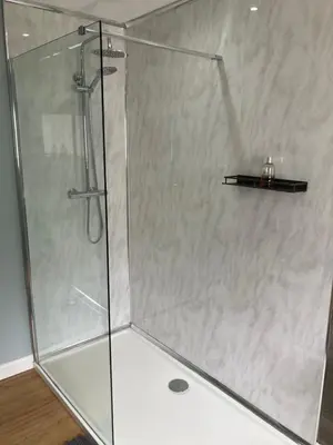 a shower with a glass door in a bathroom at 2 Bed seafront cottage in Portpatrick in Portpatrick