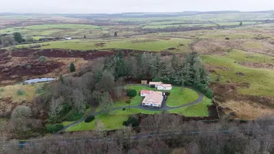 an aerial view of a house in a field at Garlies Lodge in Bargrennan