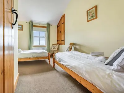 a bedroom with two beds and a window at 3 Bed in Keswick oc-sz080 in Braithwaite
