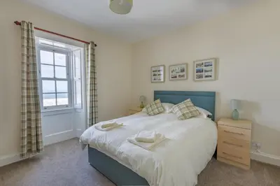 a bedroom with a large bed and a window at 3 Bed in Drummore oc-k30214 in Drummore