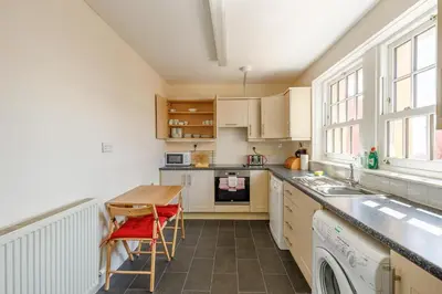 a kitchen with a sink and a table with chairs at 3 Bed in Drummore oc-k30214 in Drummore