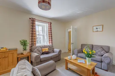 a living room with two couches and a table at 3 Bed in Drummore oc-k30214 in Drummore
