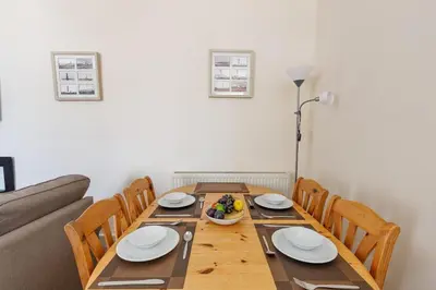 a dining room with a wooden table and chairs at 3 Bed in Drummore oc-k30214 in Drummore