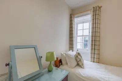 a bedroom with a bed with a mirror and a window at 3 Bed in Drummore oc-p30213 in Drummore