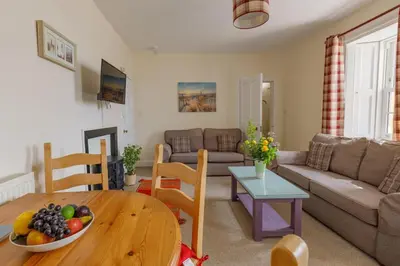 a living room with a table and a couch at 3 Bed in Drummore oc-p30213 in Drummore