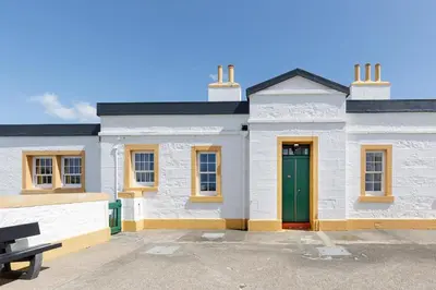 a white building with a green door in a parking lot at 3 Bed in Drummore oc-p30213 in Drummore