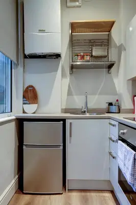 a kitchen with white cabinets and a sink at The Fullarton - Coorie Doon Stays in Troon