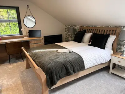 a bedroom with a bed and a desk and a computer at Field Apartment in Douglas