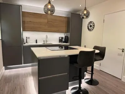 a kitchen with a table and two chairs at Field Apartment in Douglas