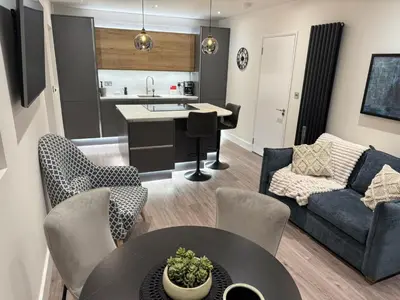 a living room with a couch and a table at Field Apartment in Douglas