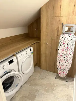 a laundry room with a washer and a washing machine at Field Apartment in Douglas