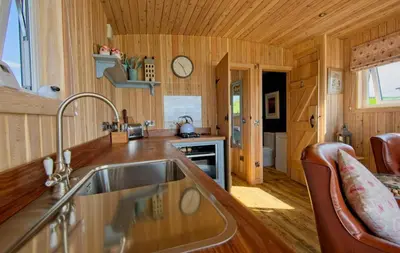 a kitchen in a tiny house with a sink at Little Beach in Gatehouse of Fleet