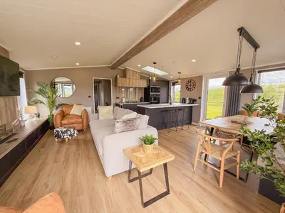 a living room with a couch and a table at Dogwood Lodge in Bassenthwaite