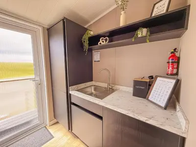 a kitchen with a sink and a counter at Dogwood Lodge in Bassenthwaite