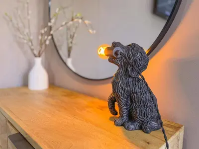 a statue of a bear drinking from a bottle on a table at Dogwood Lodge in Bassenthwaite