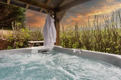 a jacuzzi tub under a gazebo at Scenery Hill Hideaways The Coach House Charming Retreat with Jacuzzi and BBQ Hut Near the Lake District in Workington