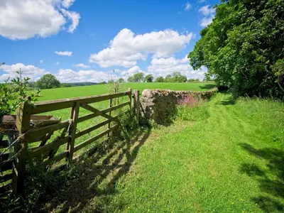 a fence on the side of a field at Beautiful Cottage in Historical Robert Burns Farm - Pass the Keys in Dumfries