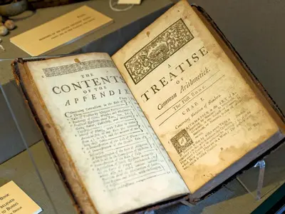 an old book on display in a glass case at Beautiful Cottage in Historical Robert Burns Farm - Pass the Keys in Dumfries