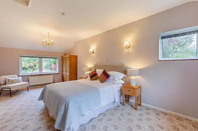 a bedroom with a large white bed and a window at 3 Bed in Loweswater oc-w30224 in Loweswater
