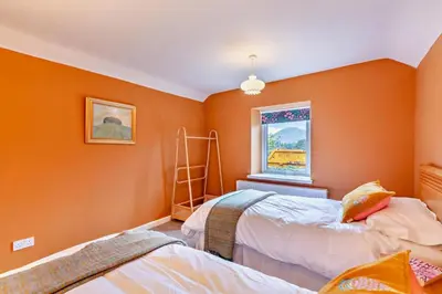 two beds in a room with orange walls at 3 Bed in Loweswater oc-w30224 in Loweswater