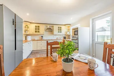 a kitchen with a wooden table and a refrigerator at 3 Bed in Longtown oc-h30069 in Longtown