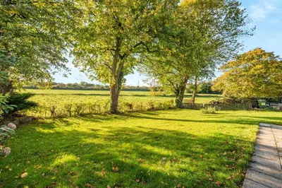 a yard with a tree and a walkway at 3 Bed in Longtown oc-h30069 in Longtown