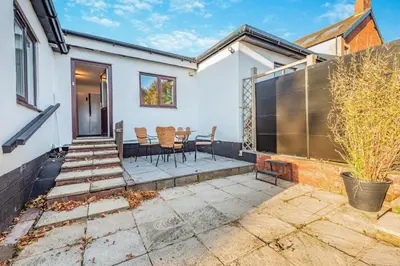 a home with a patio with a table and chairs at 3 Bed in Longtown oc-h30069 in Longtown