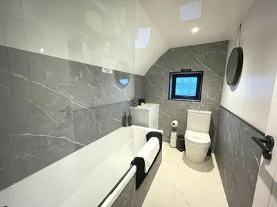 a bathroom with a tub and a toilet at Beautifully Presented Cosy Town Centre Cottage - Pass the Keys in Dumfries
