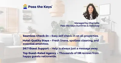 a woman is standing in a room with a poster at Cosy 3BR Getaway in Beautiful Country Park - Pass the Keys in Beattock