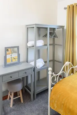 a desk with a mirror next to a desk with a chair at Shell Cottage in Whithorn