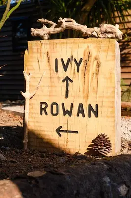 a wooden sign with the words ivy rowan on it at Rowan in Whithorn