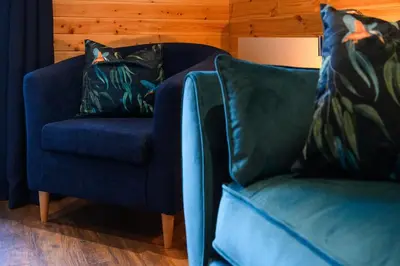 two blue chairs sitting next to each other in a living room at Rowan in Whithorn
