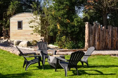 a group of chairs and a table in the grass at Ivy in Whithorn