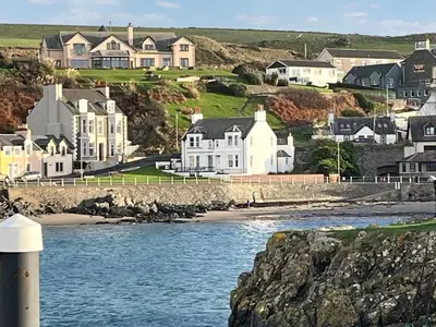 a view of a town with houses and the water at South Haven in Portpatrick