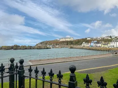 a view of a body of water next to a road at South Haven in Portpatrick