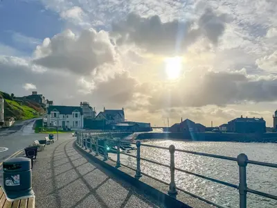 a view of a river with the sun shining at South Haven in Portpatrick
