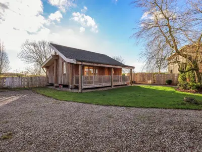 a house with a fence and a yard at Cedrus Lodge in Penrith