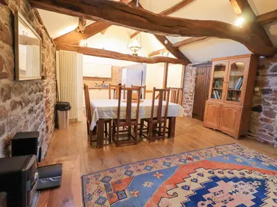 a kitchen and dining room with a table and chairs at Barn Owl Cottage in Penrith
