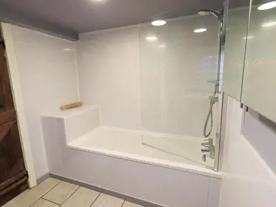 a bathroom with a shower with a glass enclosure at Barn Owl Cottage in Penrith